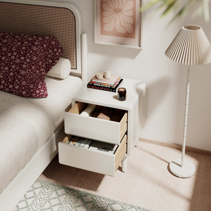 White three-drawer nightstand beside a bed