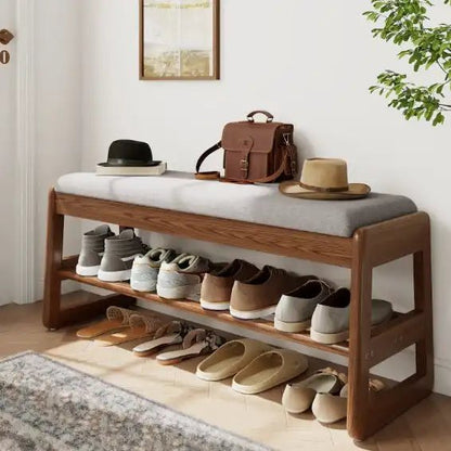 Brown 39.3-inch entryway bench styled with shoes and hats