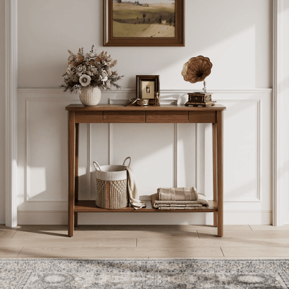 Console table styled beneath a wall mirror in an entryway