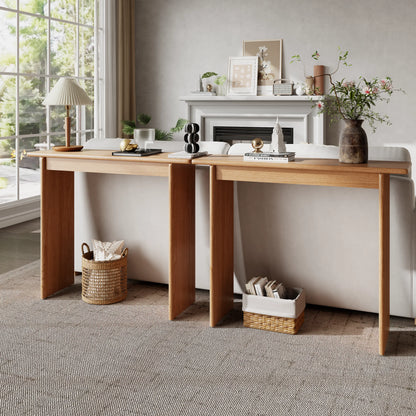 Two natural console tables placed behind a sofa