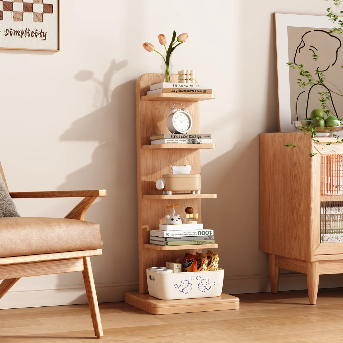 Natural five-tier bookshelf styled beside a chair and cabinet