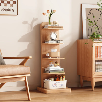 Natural five-tier bookshelf styled beside a chair and cabinet