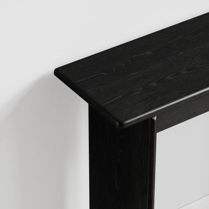 Close-up of the black console table top and rounded corner