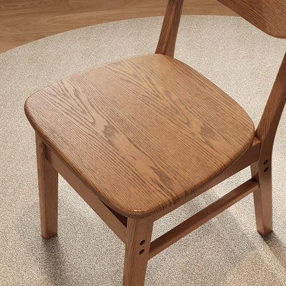 Close-up of contoured wood seat on the dining chair