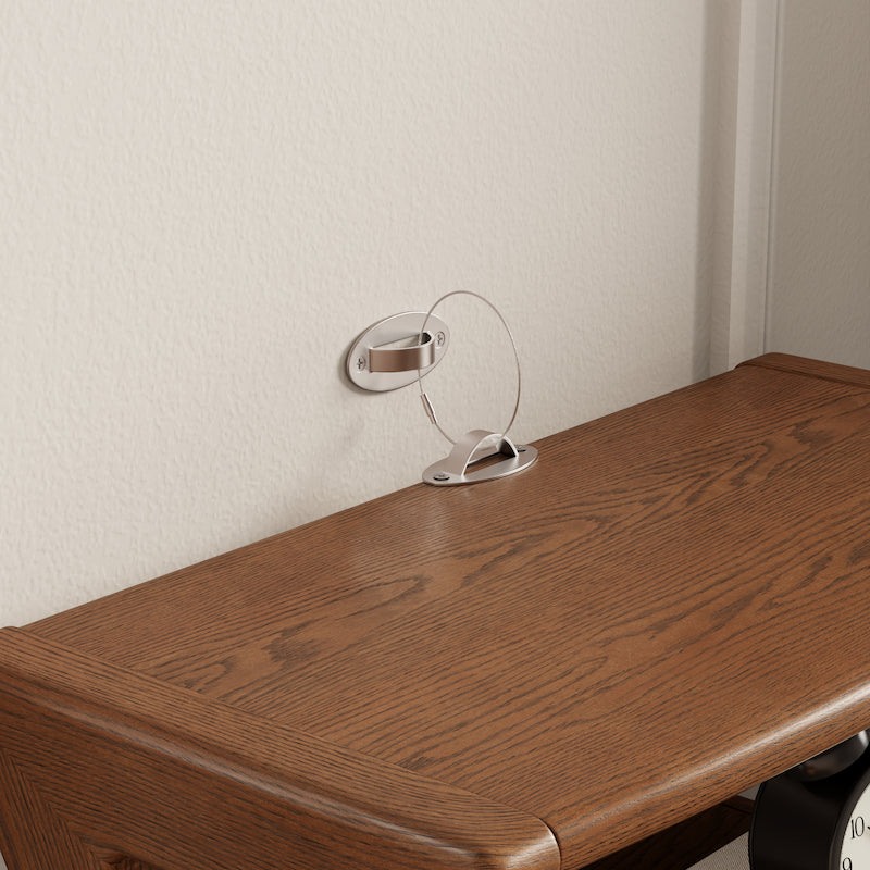 Wooden surface with a small round mirror attached to the wall above it.