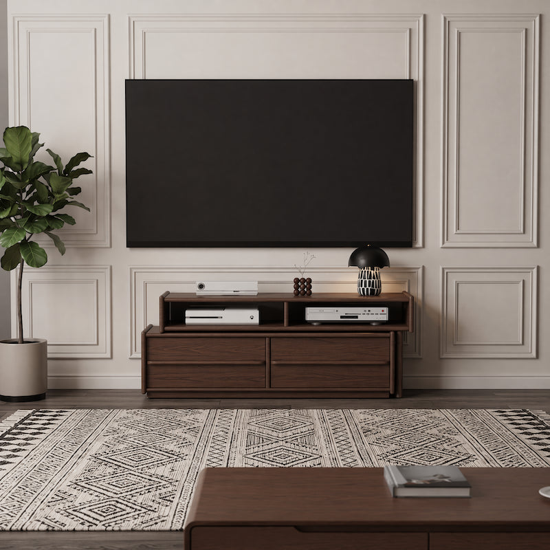 Modern living room with a wooden TV stand, television, and decorative items.