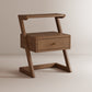 Wooden side table with a drawer on a beige background