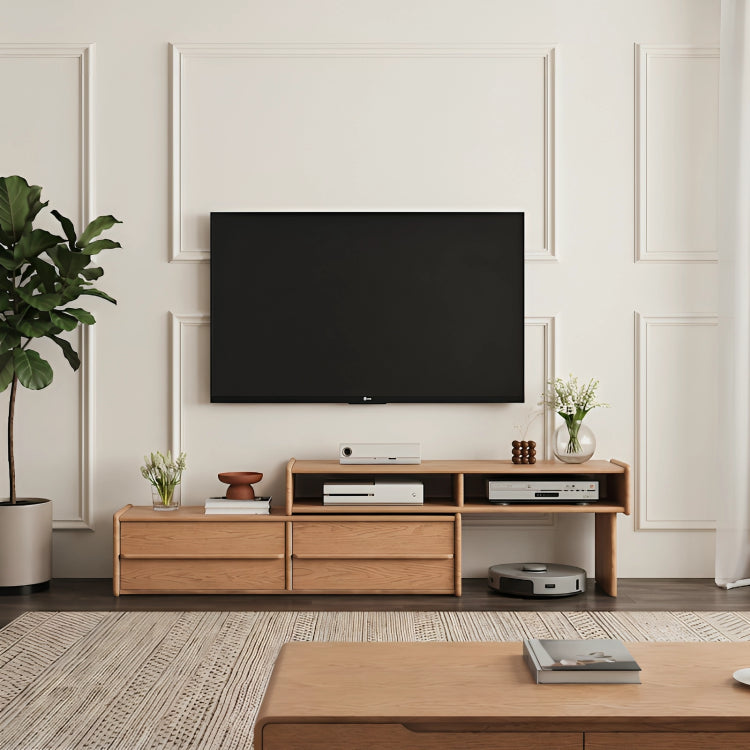 Modern living room with a wooden TV stand, television, and decorative items.