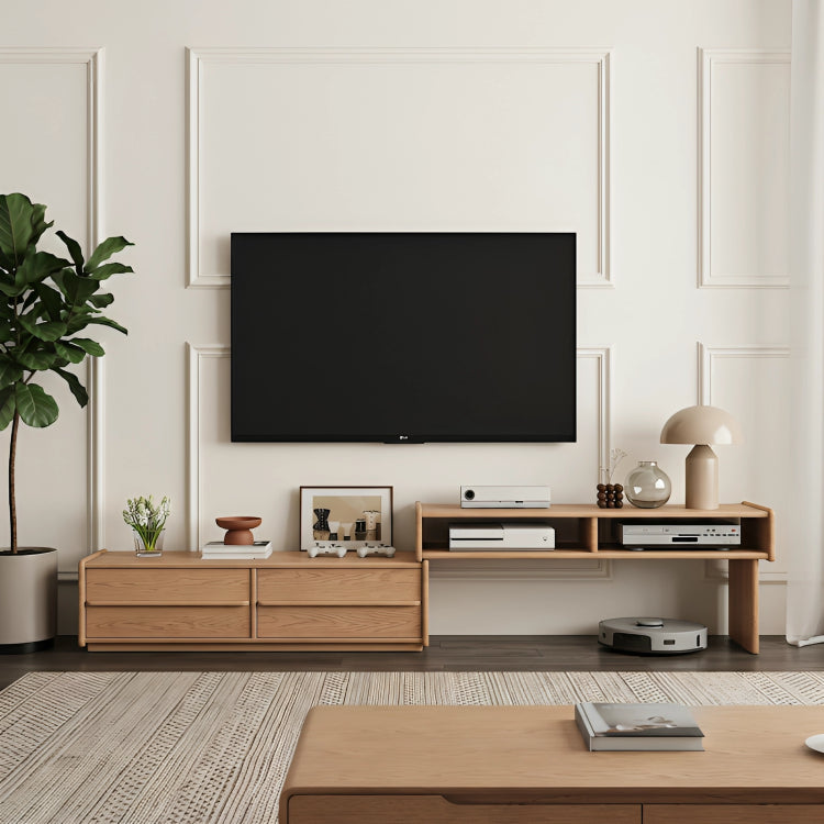 Modern living room with a flat-screen TV mounted on the wall, wooden entertainment console, and decor items.
